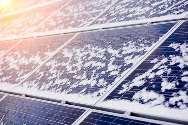 solar panel covered with light snow